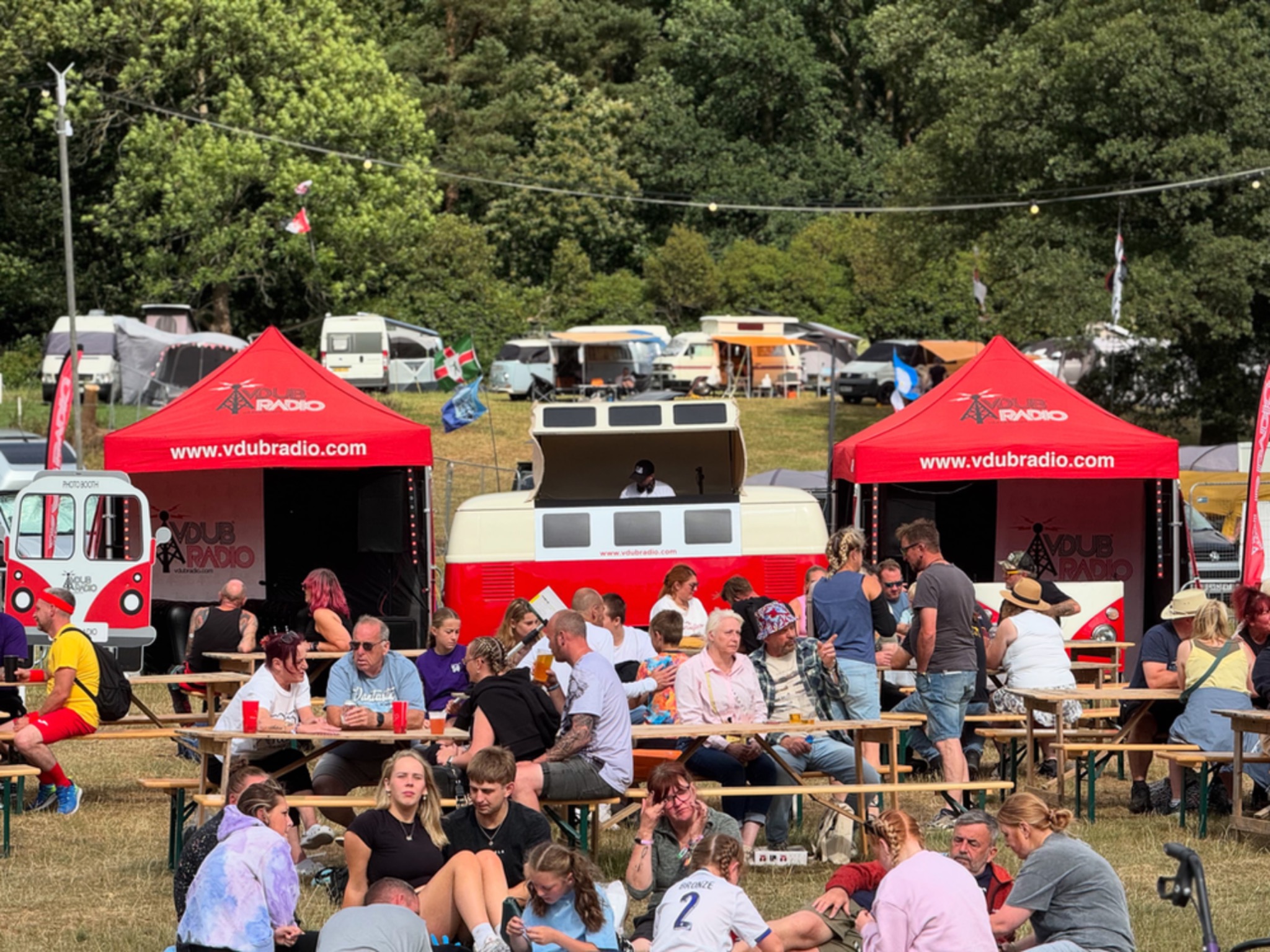 The VW DJ Booth at a festival surrounded by people enjoying the music